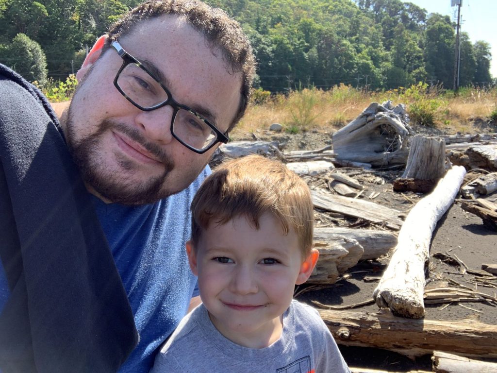 man and son on a river bank