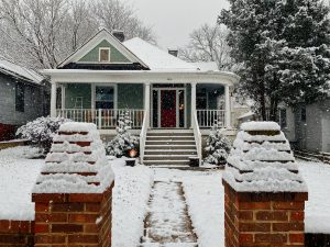 snow covered wooden house near trees