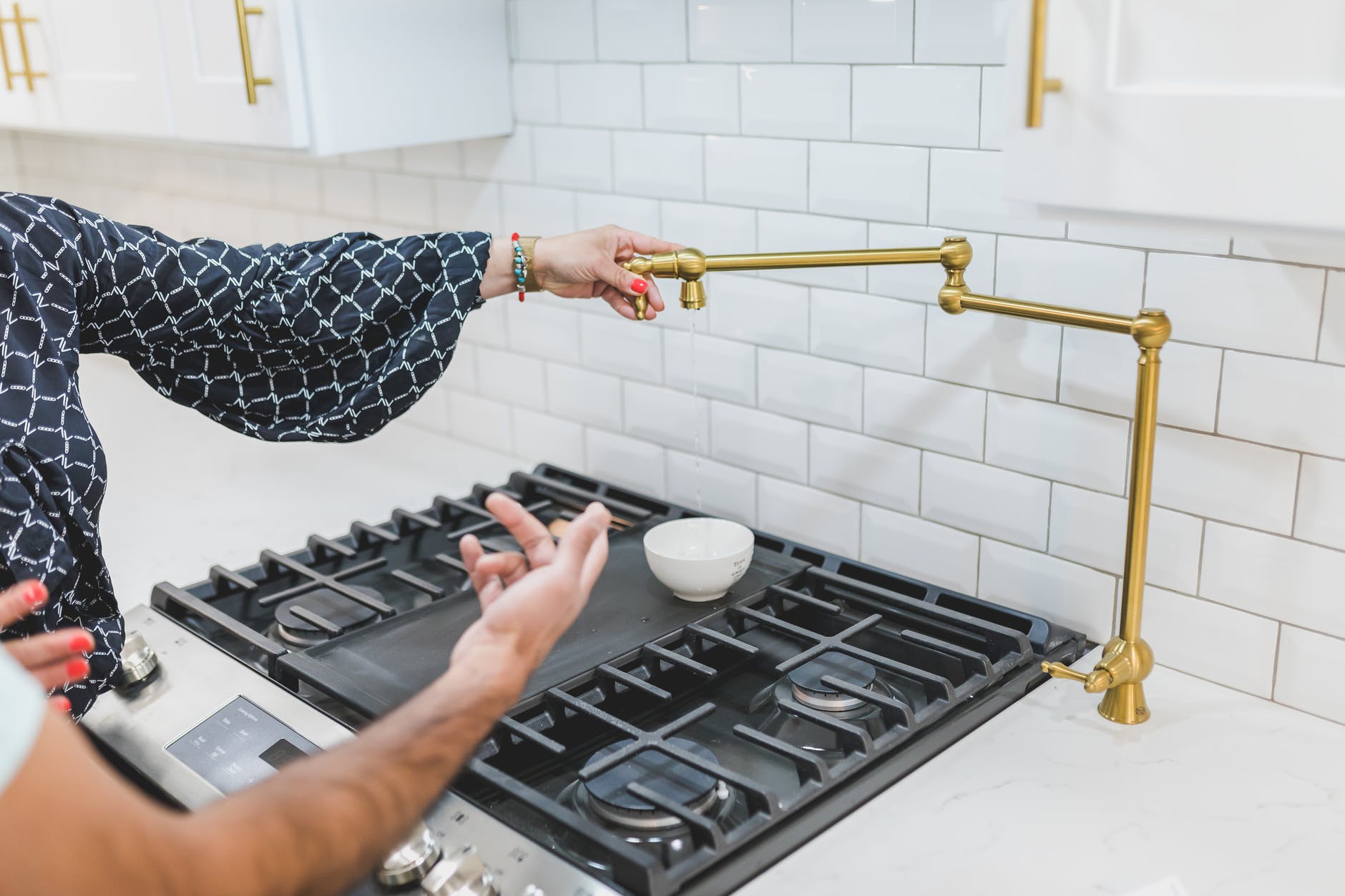 a person holding a brass faucet tube